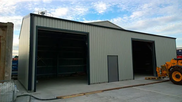 Grey clad industrial unit with two large open bays