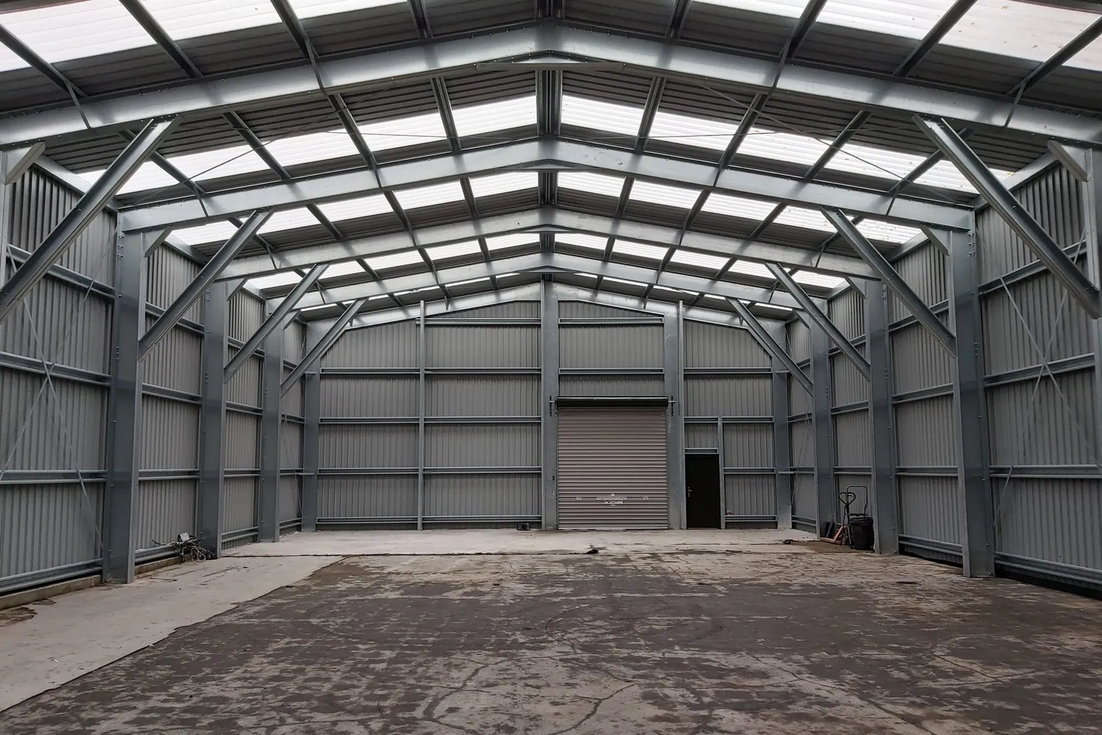 Inside a steel unit showing the portal frames and roof lights